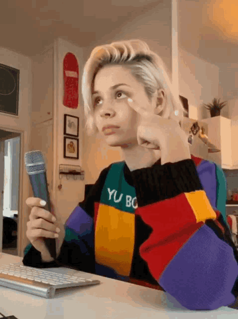 a woman wearing a sweater that says yu bo on it