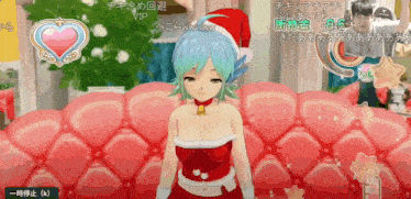 a girl in a santa suit is sitting on a pink couch