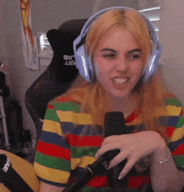 a woman wearing headphones and a striped shirt is sitting in a chair that says rest lab