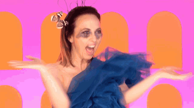 a woman in a blue dress with a butterfly on her hair