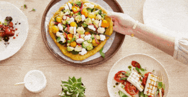 a person is cutting a pizza with a knife