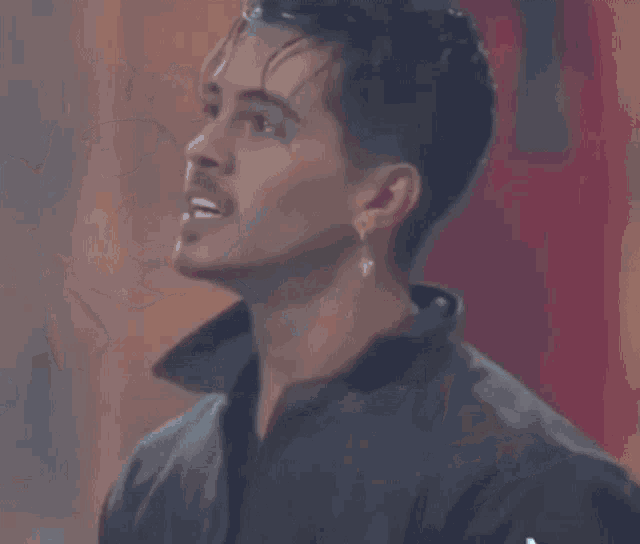 a close up of a man sticking his tongue out