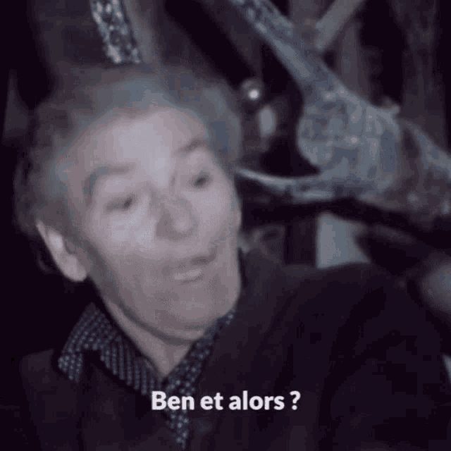 a man in a suit says ben et alors in french