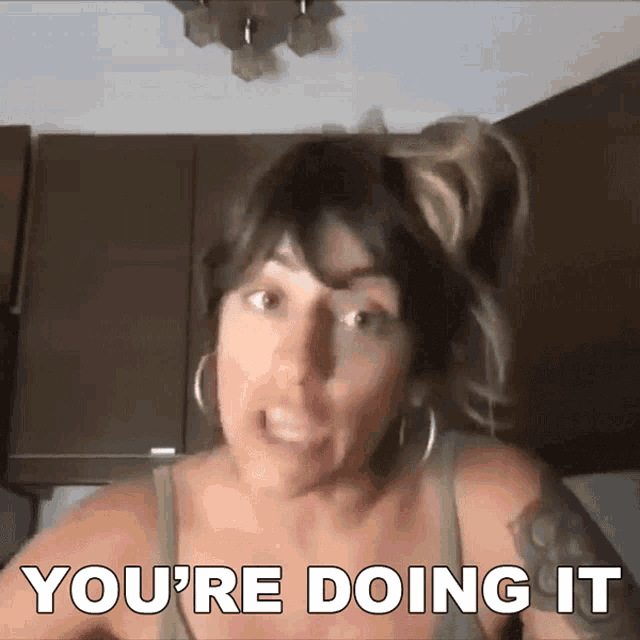 a woman says " you 're doing it " while making a face