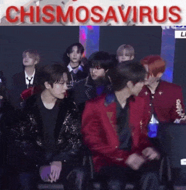 a group of young men are sitting in a room with the words chismosaurus written on the bottom .