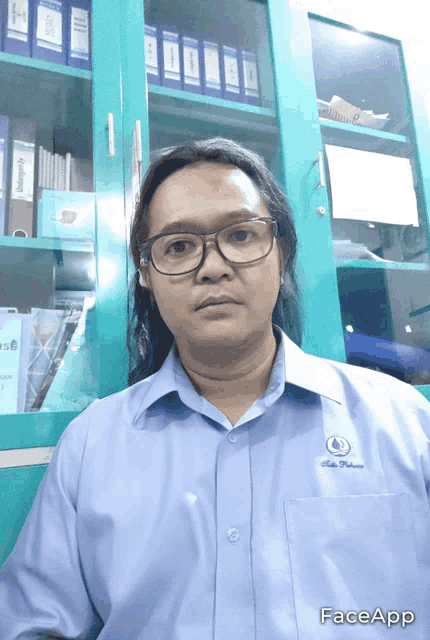 a man wearing glasses and a shirt that says faceapp on it
