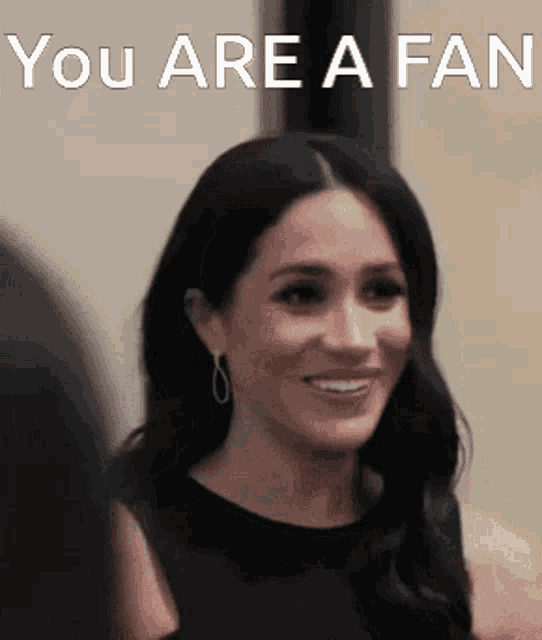 a woman is smiling with the words " you are a fan " above her