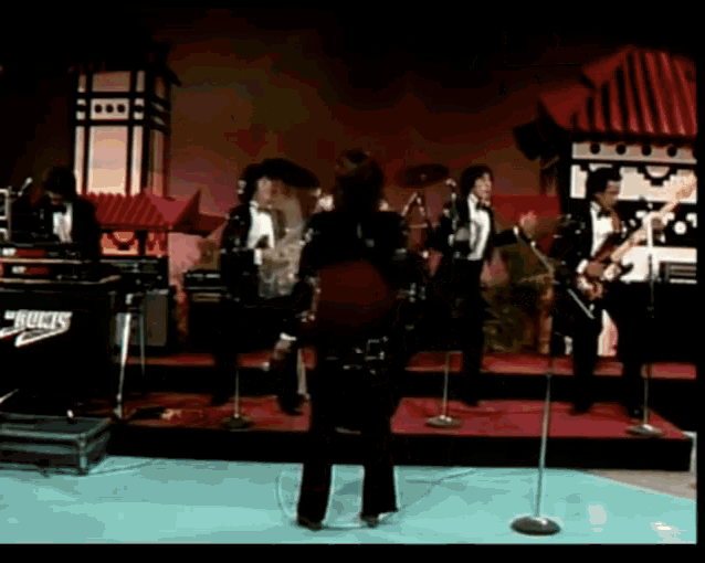 a group of musicians are performing on a stage with a box that says ' rucks ' on it