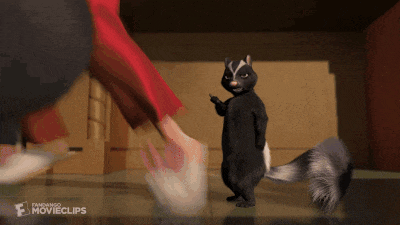 a cartoon skunk is standing next to a person 's foot with a movie clips logo on the bottom right