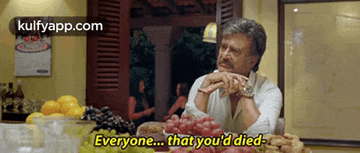 a man is sitting at a table with fruit and vegetables and says everyone that you 'd died .