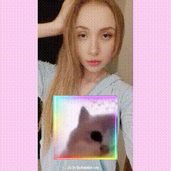 a girl is taking a selfie with a dog in the background
