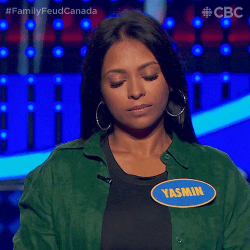 a woman wearing a name tag with yasmin on it