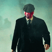 a man with a red mask on his face is wearing a hat