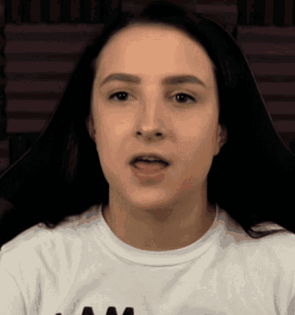 a close up of a woman 's face with a white shirt that says am on it