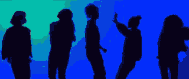a group of people are dancing in front of a blue light .
