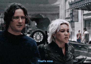 a man and a woman are standing next to each other and the man says that 's nice
