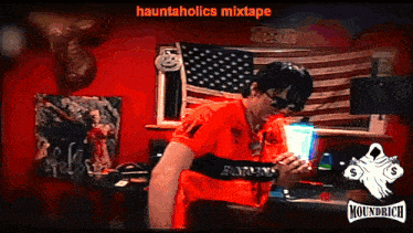 a man in a red shirt stands in front of an american flag with hauntaholics mixtape written on the bottom