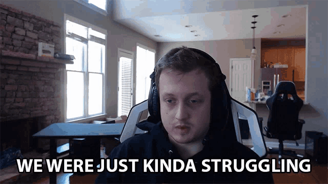 a man wearing headphones says " we were just kinda struggling " while sitting in a chair