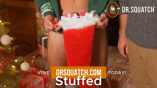 an advertisement for drsquatch.com stuffed shows a man holding a christmas stocking