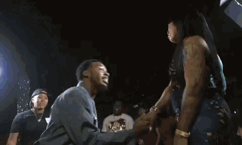 a man is kneeling down to propose to a woman