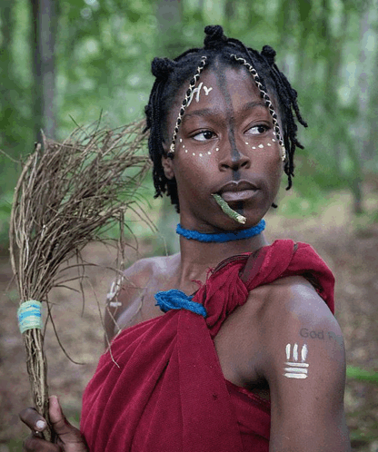 a woman with a tattoo that says god on her arm