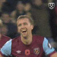 a soccer player wearing a maroon and blue jersey that says betway on it