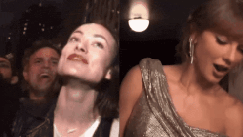 a woman in a silver dress is standing next to a man in a crowd