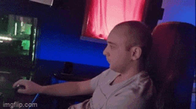 a man is sitting in front of a computer with imgflip.com on the bottom right