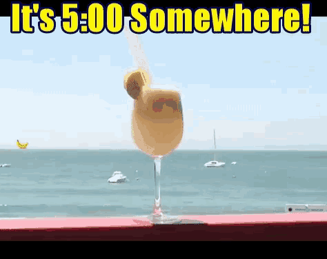 a drink in a wine glass with the words it 's 5:00 somewhere