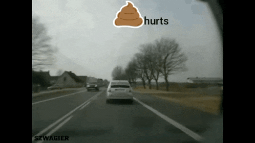 a white car is driving down a road with a sticker that says hurts on it