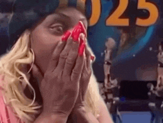 a woman with red nails is covering her face with her hands in front of a sign that says 025 .