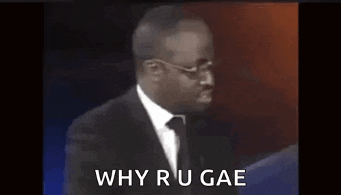 a man in a suit and tie is giving a speech and saying `` why r u gae `` .
