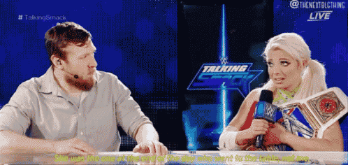 a man and a woman are sitting at a table with a sign that says talking smack