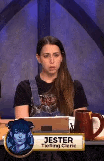 a woman sitting at a desk with a sign that says jester tieflling cleric