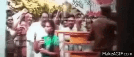 a group of people are standing in front of a sign that says makeagif.com