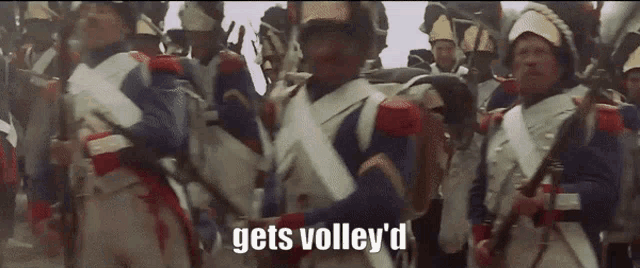 a group of soldiers marching with the words gets volley 'd in the corner