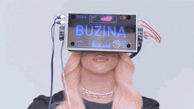 a woman is wearing a virtual reality headset and holding her hands up in the air .