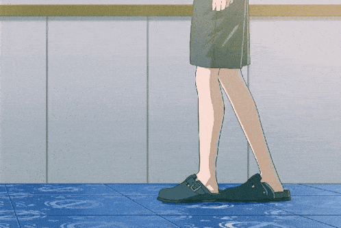 a man is kneeling down on a blue tile floor with his legs crossed