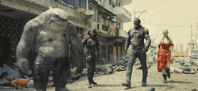 a group of people are standing on a dirt road with a shark in the middle