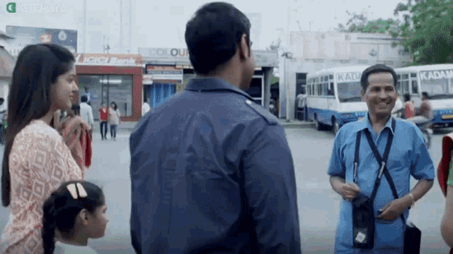 a group of people are standing in front of a building that says icici bank on it