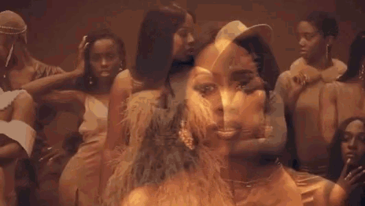 a group of women are standing next to each other and dancing in a room .