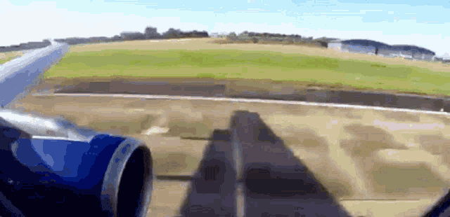 a plane is taking off from a runway and the shadow of the plane is on the ground