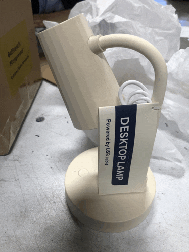 a white desk lamp that is powered by sss