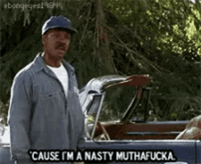 a man is standing in front of a car and says cause i 'm a nasty muthafucka