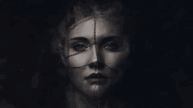 a woman with chains around her face has white eyes