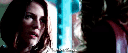 a woman is talking to another woman in a dark room and says `` i 'm here . always . ''