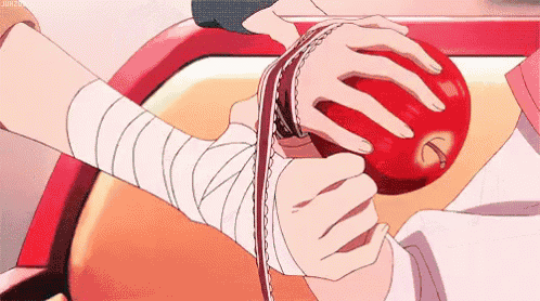 a person with a bandage on their wrist is holding an apple .