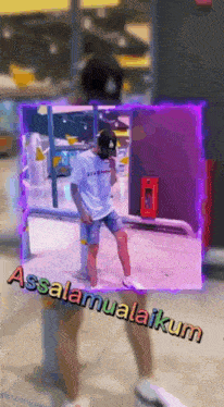 a man in a white shirt is standing in front of a purple background that says assalamualaikum