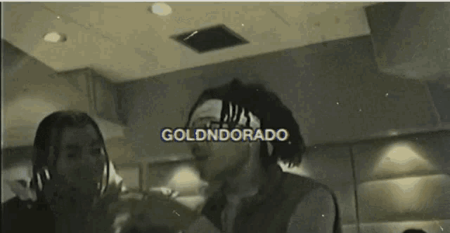 a black and white photo of two men with golddorado written on the top