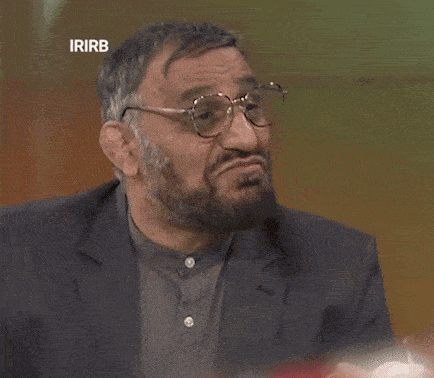 a man with glasses and a beard is on a television screen that says ' irirb ' on it